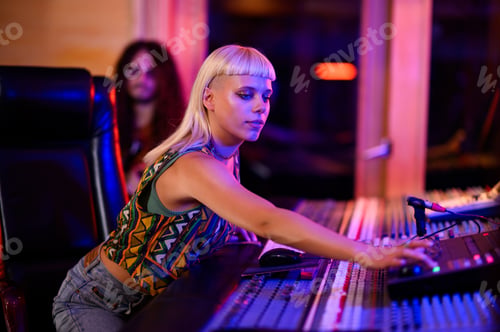 Preview: Recording technician handling mixing console, neon reflection, alternative, indie.