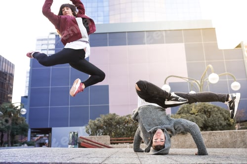 Preview: Young happy couple dancing on the street