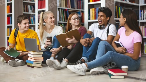 Preview: Group of teenage friends laughing while preparing for exams