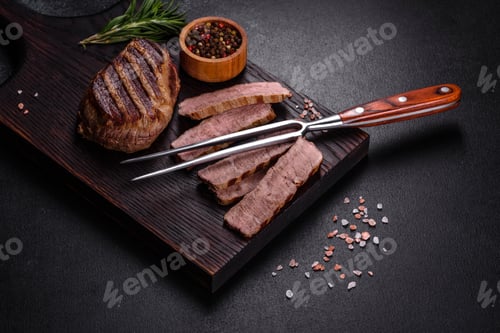 Preview: Fresh juicy delicious beef steak on a dark background