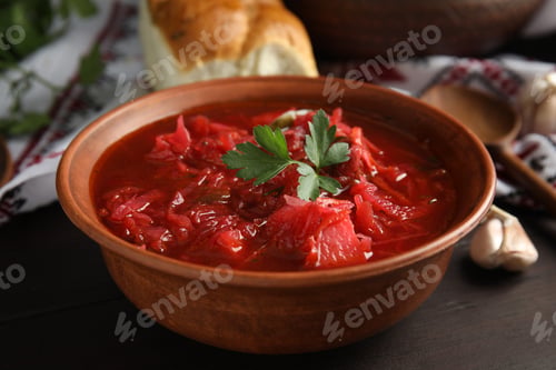 Preview: Stylish brown clay bowl with Ukrainian borsch served on wooden table, closeup