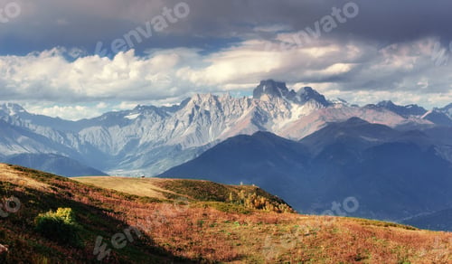 Preview: Autumn landscape and snow-capped mountain peaks. View of the mou