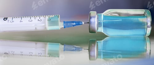 Preview: Vial filled with liquid vaccine in medical lab with syringe.
