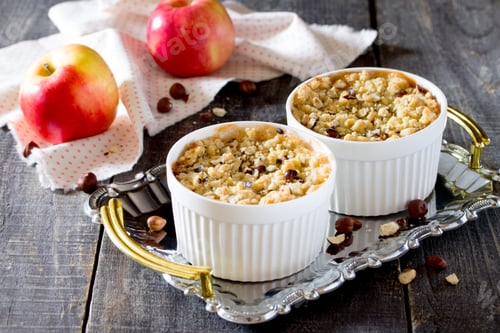 Preview: Dessert crumble with apple and nuts on a dark wooden table
