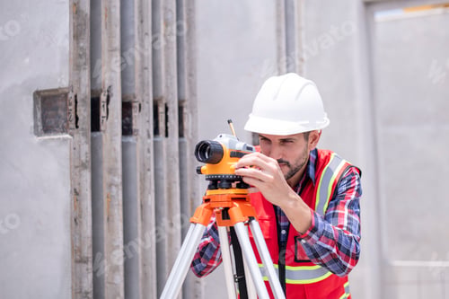 Preview: Engineer or worker construction architecture wear safety uniform and helmet with equipment theodolit