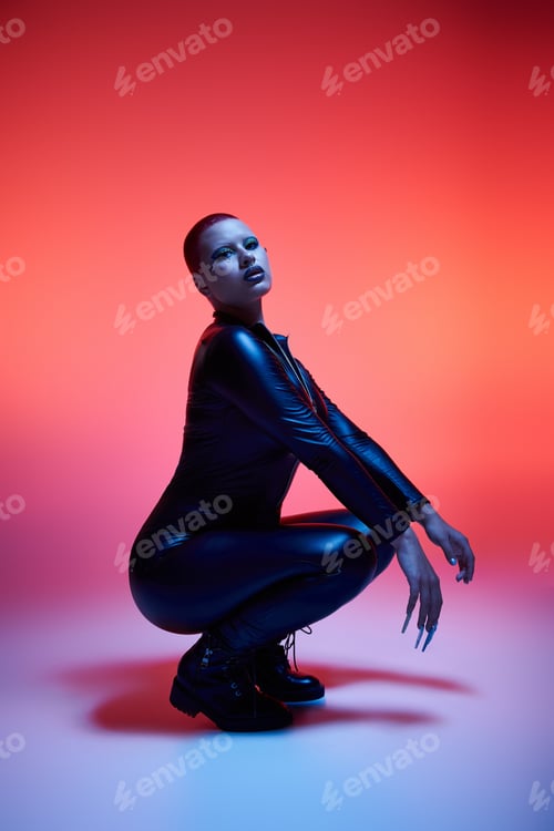 Preview: Bold young woman with short pink hair showcases unique style in a vibrant studio setting