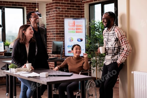 Preview: Diverse group of people having fun in business workplace on break