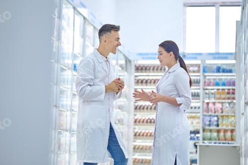 Preview: Two cheerful drugstore workers having a conversation
