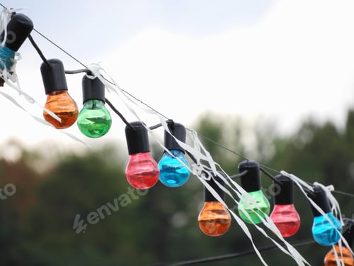 Preview: Row of colorful lightbulbs hanging on a string