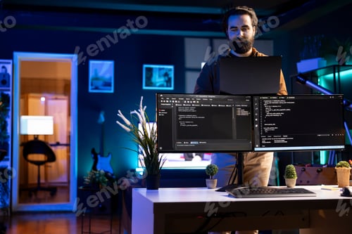 Preview: Programmer installing fortified code on laptop, crosschecking with PC screens