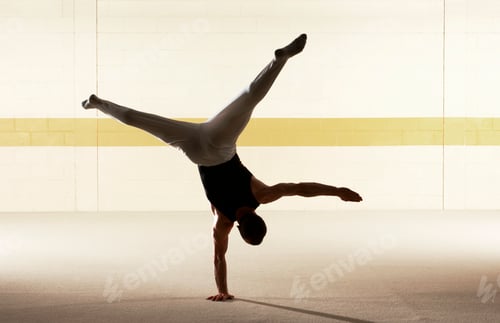 Preview: Dancer performing a handstand with perfect balance against a minimalist backdrop