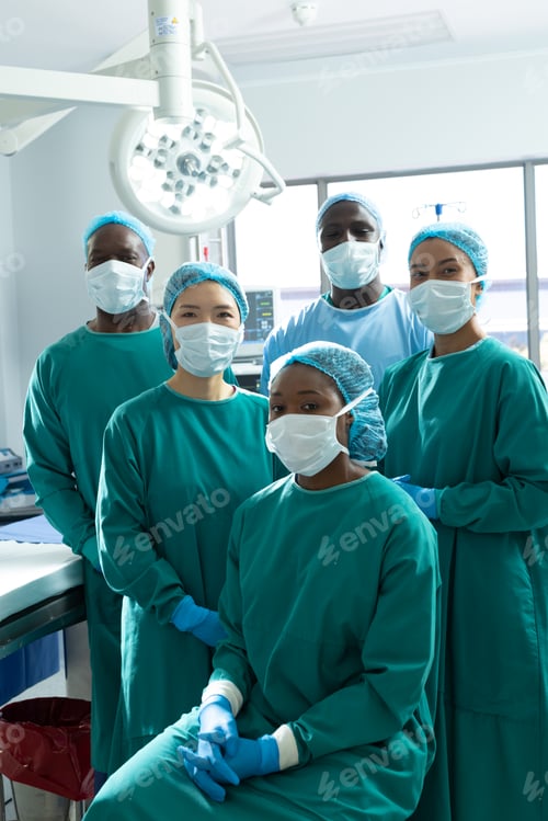 Preview: Vertical portrait of diverse group of surgeons ready for surgery in operating theatre, copy space