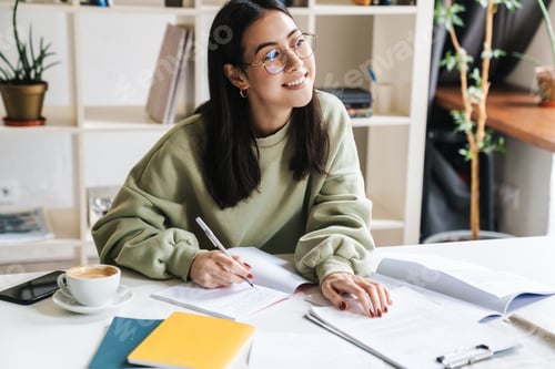 Preview: Attractive young girl student studying at the college library