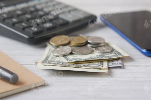Preview: close up of wallet, cash and coins on table