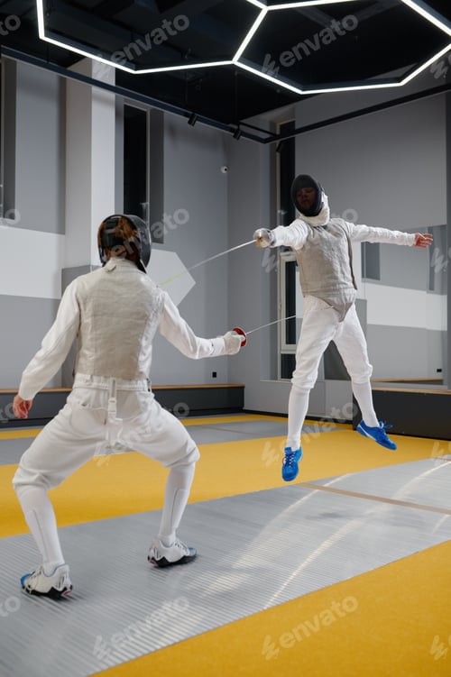 Preview: Two fencers sparring during training session in professional martial art school