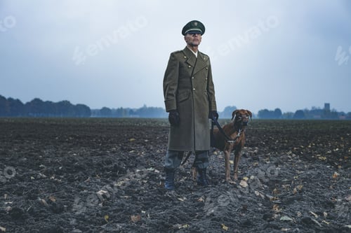 Preview: Patrolling Retro 1940S Military Officer Standing With Dog On Farmland.