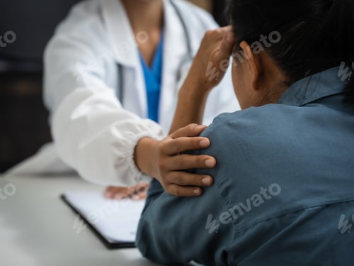Preview: Mature chinese woman in consultation with a doctor with abdominal pain. depression.