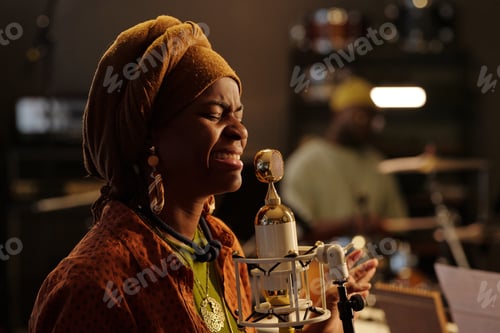 Preview: Singing African American Woman Wearing Turban in Recording Studio