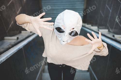 Preview: young woman outdoor posing wearing alien mask