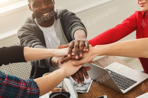 Preview: Young Diverse Business People Putting Hands Together At Working Table Background. Successful