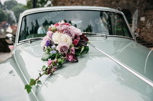 Preview: Bouquet of colorful flowers on a wedding car.