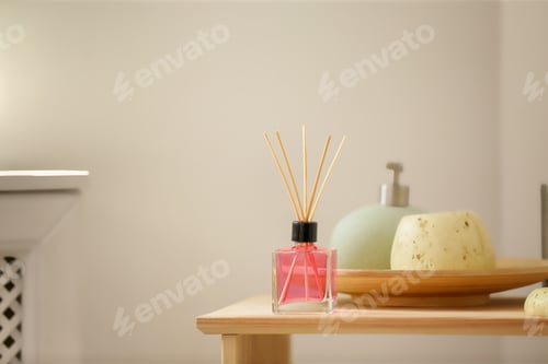 Preview: Aromatic reed air freshener and toiletries on table indoors
