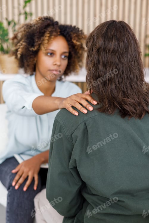 Preview: African American female psychologist conducts an appointment with a patient in the office. mental