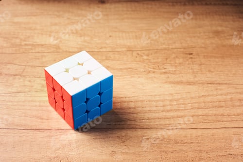 Preview: Dobrush, Belarus - 3 February 2019. Rubics cube on a wooden background, top view