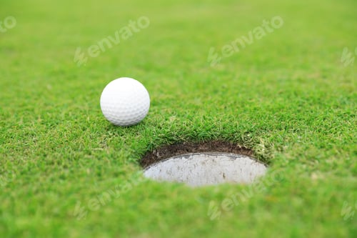 Preview: Golf ball near hole on green course