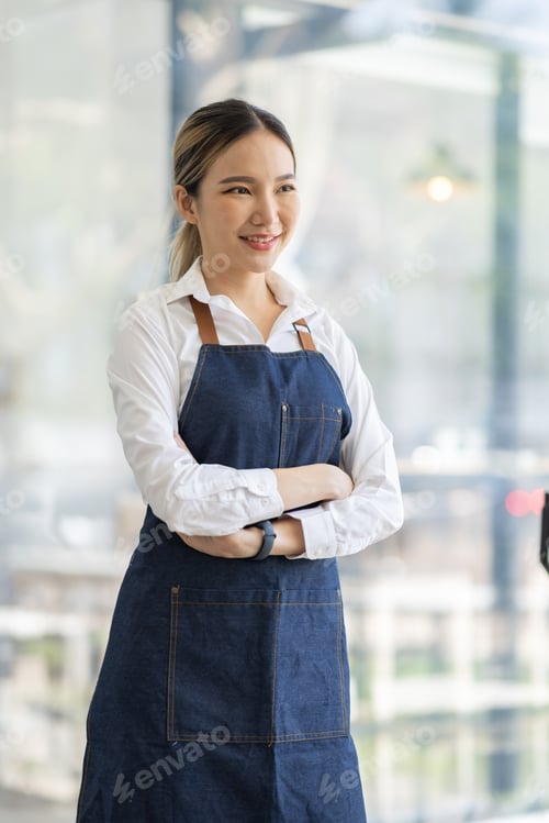 Preview: Asian Happy business woman is a waitress in an apron, the owner of the cafe stands at the door with
