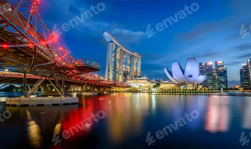 Preview: Illuminated Singapore waterfront in the evening, with Marina Bay Sands Hotel and ArtScience Museum.