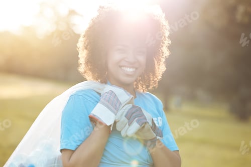 Preview: Nature portrait, community volunteer and happy woman cleaning garbage, eco waste and plastic trash.