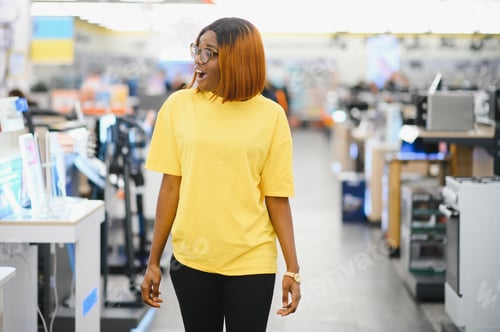 Preview: young african american woman shopping for appliance in supermarket