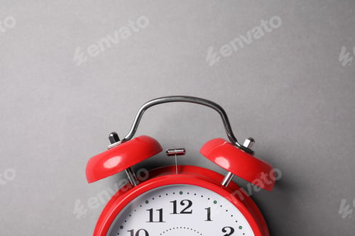 Preview: Red alarm clock on grey background, top view