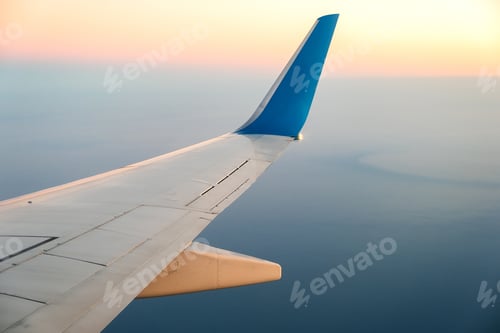 Preview: View from airplane on the aircraft white wing flying over ocean landscape