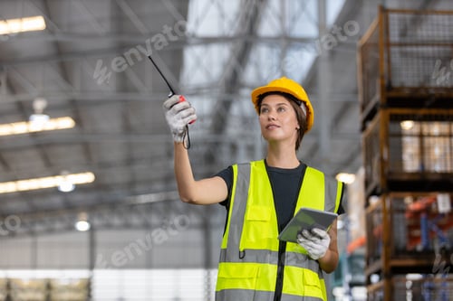 Preview: women engineer holding walkie talkie and tablet quality control