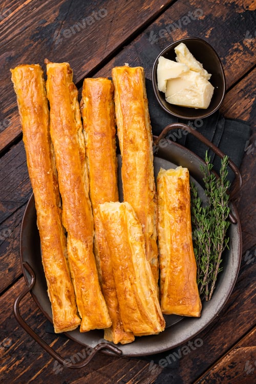 Preview: Homemade pastry, Bread sticks with cheese and salt. wooden background. top view
