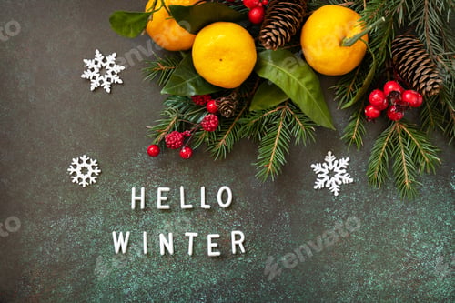 Preview: Winter composition with fir branches, cones and tangerines on a stone background.