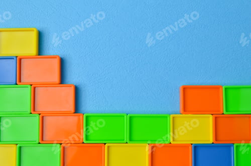 Preview: Plastic toy building blocks isolated on a blue background