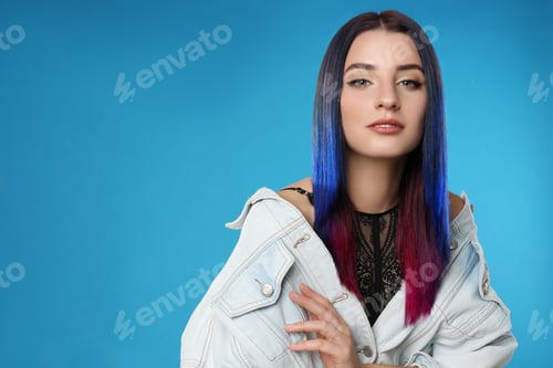 Preview: Young woman with bright dyed hair on blue background, space for text