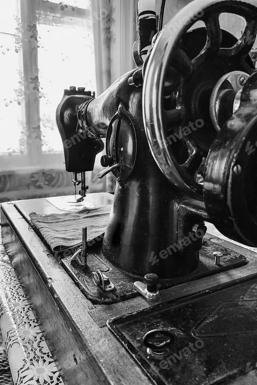 Preview: Old sewing machine stands on the table at home ready to work and sew.