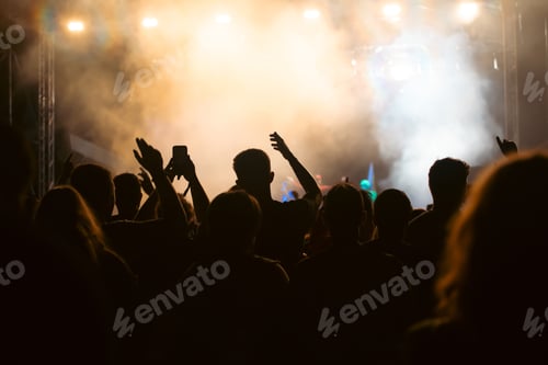 Preview: Abstract photo of crowd at concert and blurred stage lights.