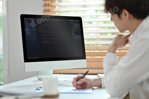 Preview: Coding programmer, software engineer sitting at desk, working in software development office.