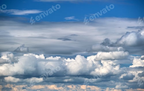 Preview: Bright landscape of white puffy cumulus clouds on blue clear sky.