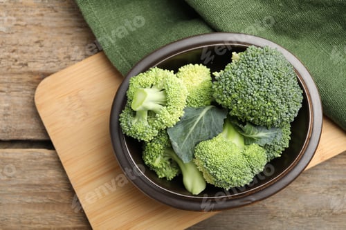 Preview: Fresh broccoli florets in bowl on wooden table, top view
