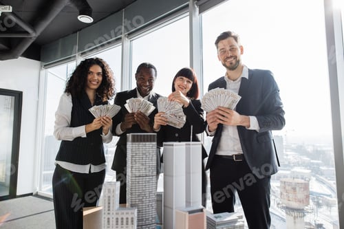 Preview: Team of diverse multiethnic business people holding bundle of american dollar cash money