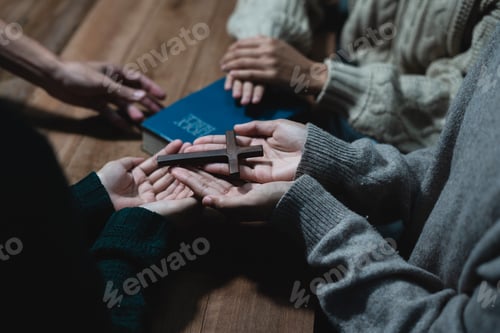 Preview: Asian men and women hands praying to god with the bible.