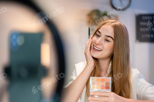 Preview: Caucasian young beauty blogger recording video content about cosmetics.