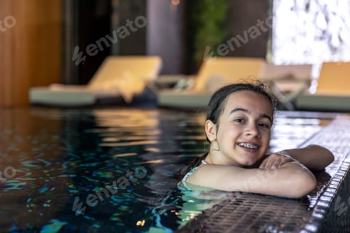 Preview: Portrait girl having fun in indoor swimming pool.