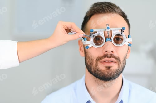 Preview: Male patient under eye vision examination in eyesight ophthalmological correction clinic